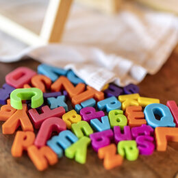Buchstaben auf einem Tisch: Der Schritt von der Kita in die Schule ist für Kinder und Eltern groß.